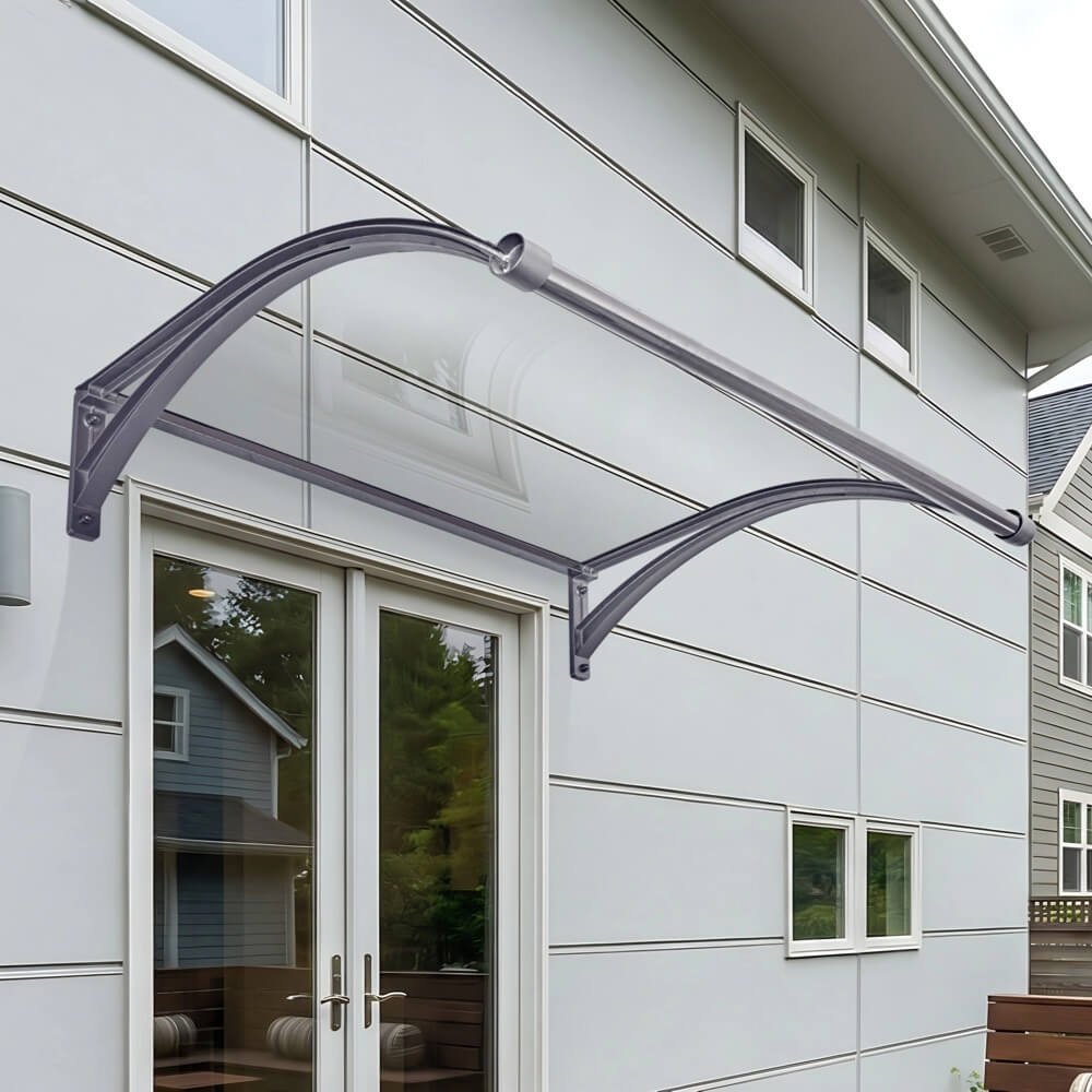 Elegant curved door canopy featuring clear polycarbonate glazing and sturdy aluminum brackets, installed over a residential double door for premium rain protection.