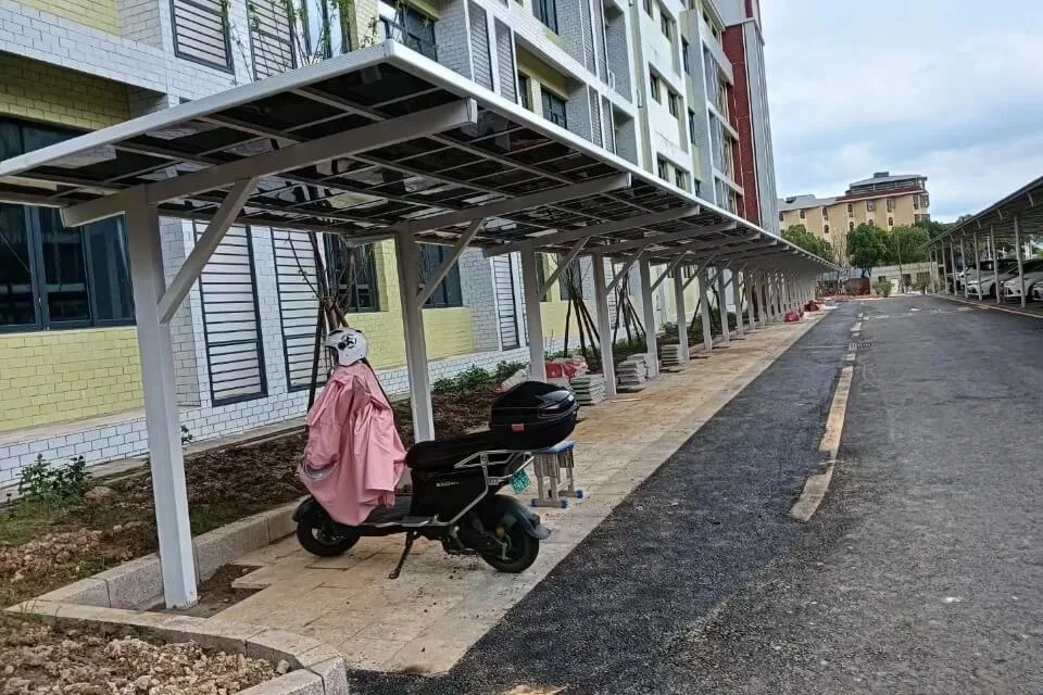 Electric scooter parked safely under a newly installed custom aluminum carport in a Guangdong community, highlighting our turnkey engineering and on-site installation services.