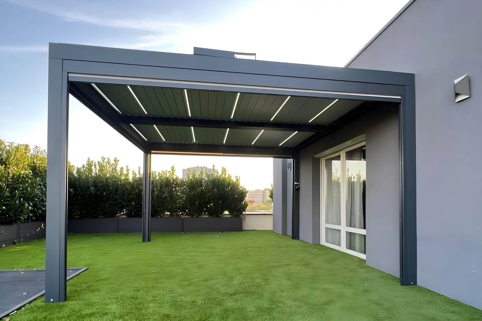 Beautifully installed custom dark grey aluminum pergola in a Calgary backyard, featuring a modern modular design that seamlessly integrates with the residential landscape.