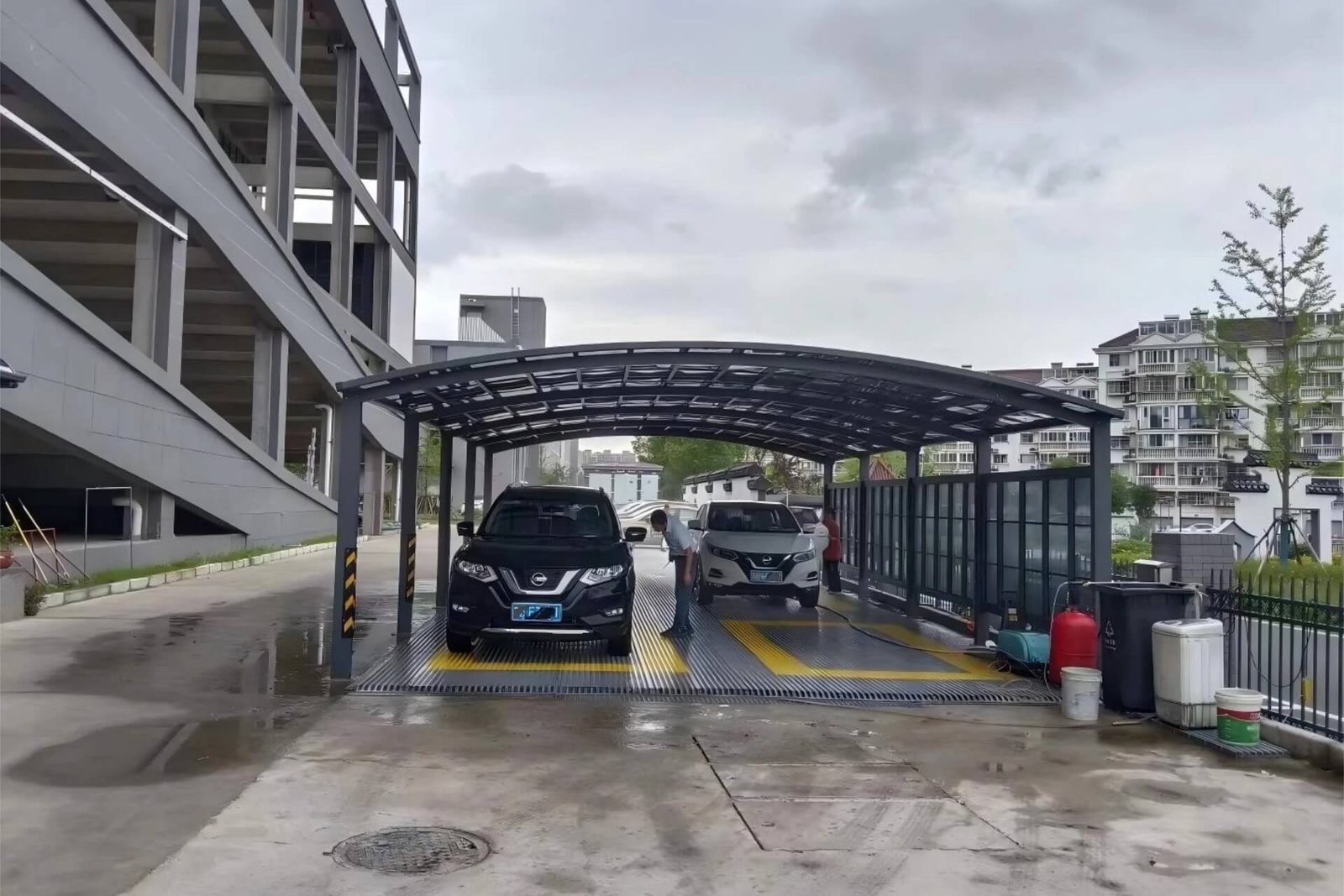 Custom large-scale aluminum self-service car wash carport installed in a Shenzhen commercial parking lot, showing the real-world commercial application.