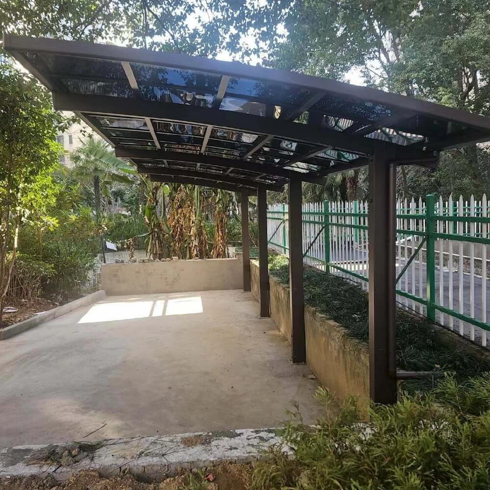 Commercial-grade single cantilever aluminum carport with a tinted polycarbonate roof, offering robust vehicle protection and high maneuverability for driveways.