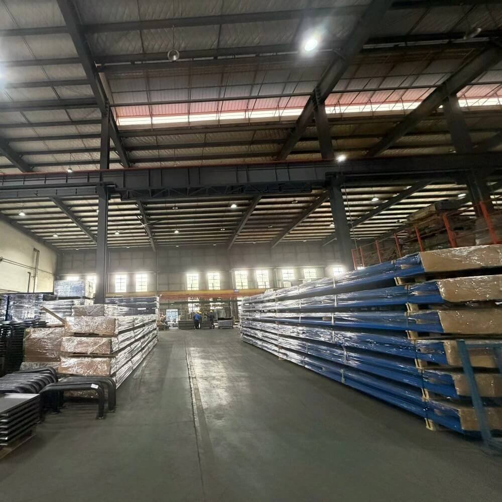 Massive inventory of wrapped aluminum extrusions stacked inside a 45,000 sqm state-of-the-art manufacturing facility, ready for outdoor structure production.