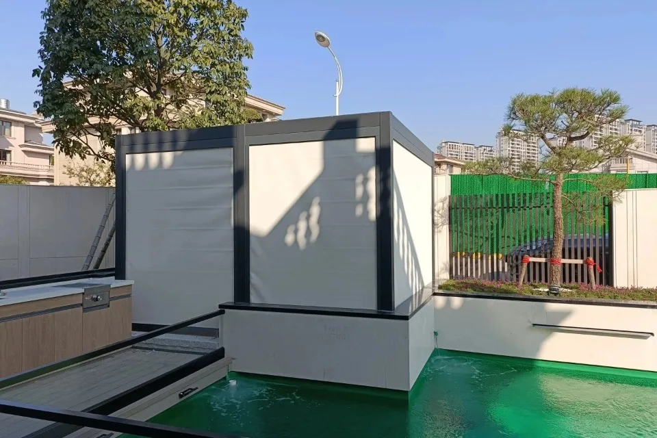 Custom outdoor pergola with bespoke white opaque motorized zip screens fully lowered, providing a secure and private poolside changing area.