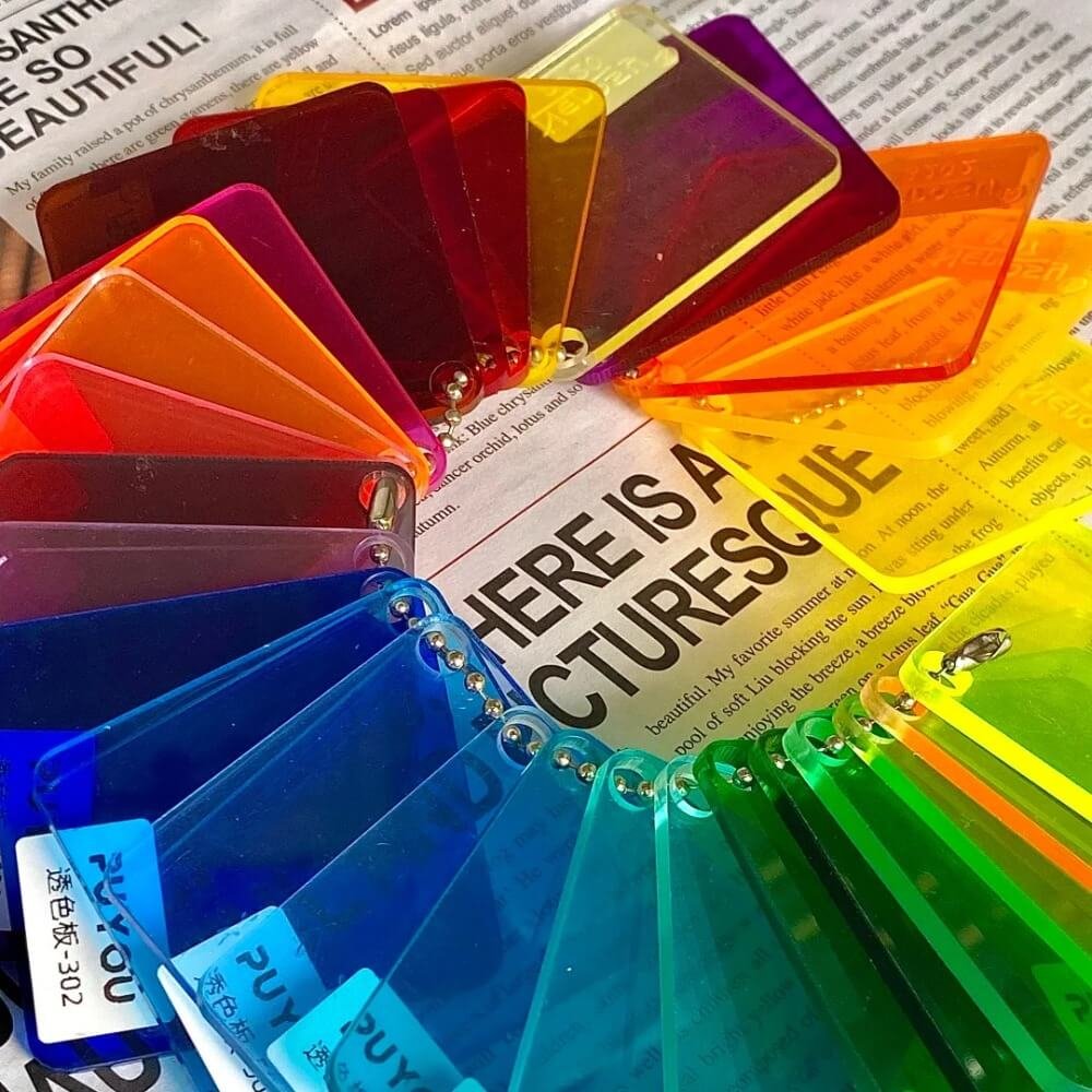 A wide array of vibrant polycarbonate solid sheet color samples fanned out, showcasing the extensive tint options available for customizing carport roof light transmission.