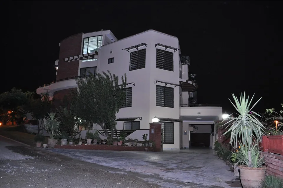 Multiple spliced aluminum arched canopies seamlessly mounted over extra-wide windows on a modern villa facade, providing reliable all-weather coverage.