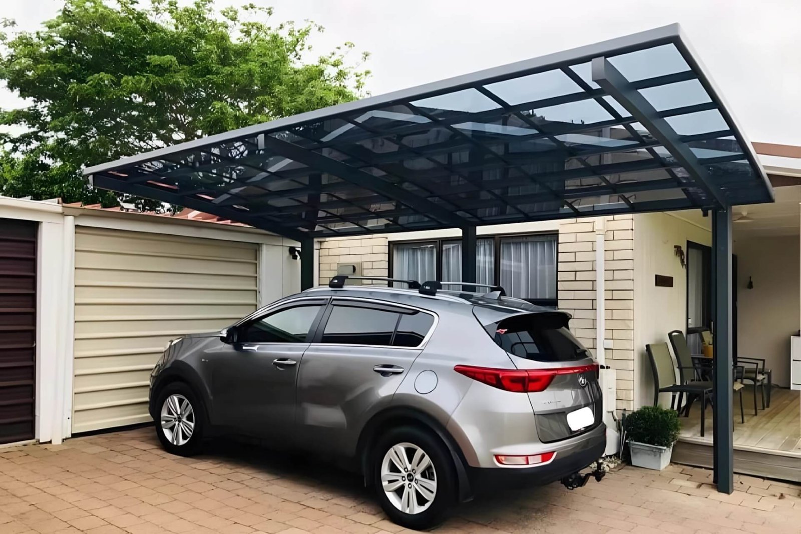 A large modern luxury home featuring an attached black-framed aluminum pergola canopy with translucent roof panels installed over a spacious rooftop terrace, creating a seamless outdoor living space.