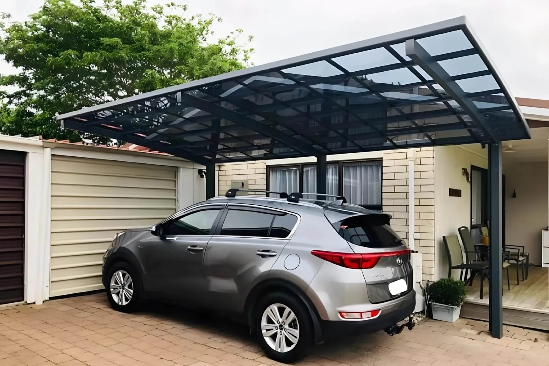 A large modern luxury home featuring an attached black-framed aluminum pergola canopy with translucent roof panels installed over a spacious rooftop terrace, creating a seamless outdoor living space.