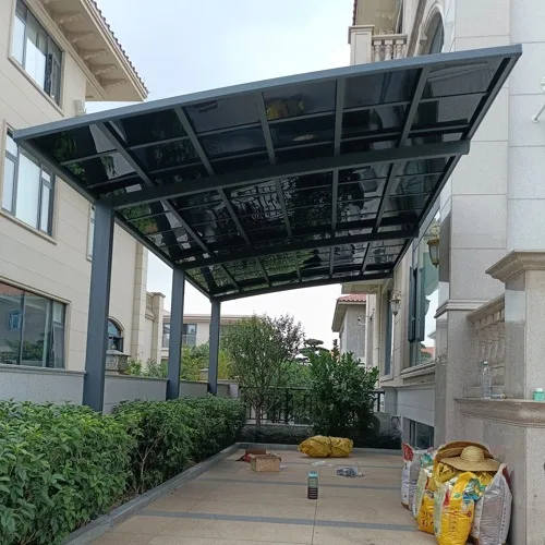 A modern cantilever aluminum carport installed next to a residential villa, featuring a space-saving single-sided post design and UV-blocking polycarbonate roof.
