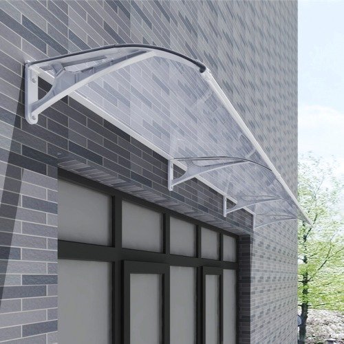 A modular extended polycarbonate awning installed on a grey brick wall above a commercial entrance, showcasing the seamless interlocking connection of multiple brackets for wide coverage.